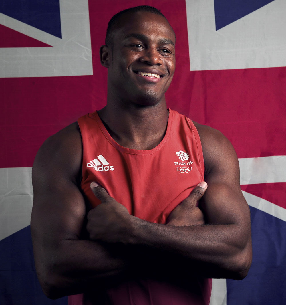 Chev posing with UK flag behind, red outfit